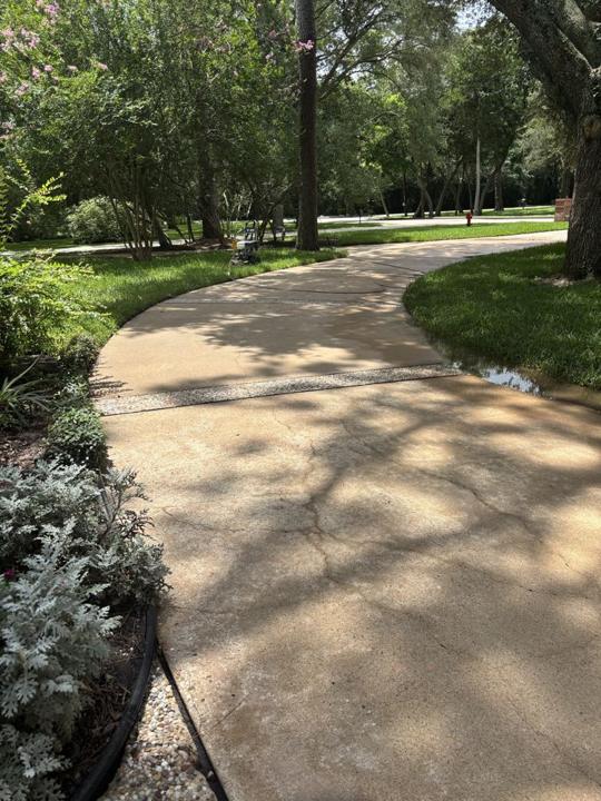 Curved driveway with hoses after cleaning