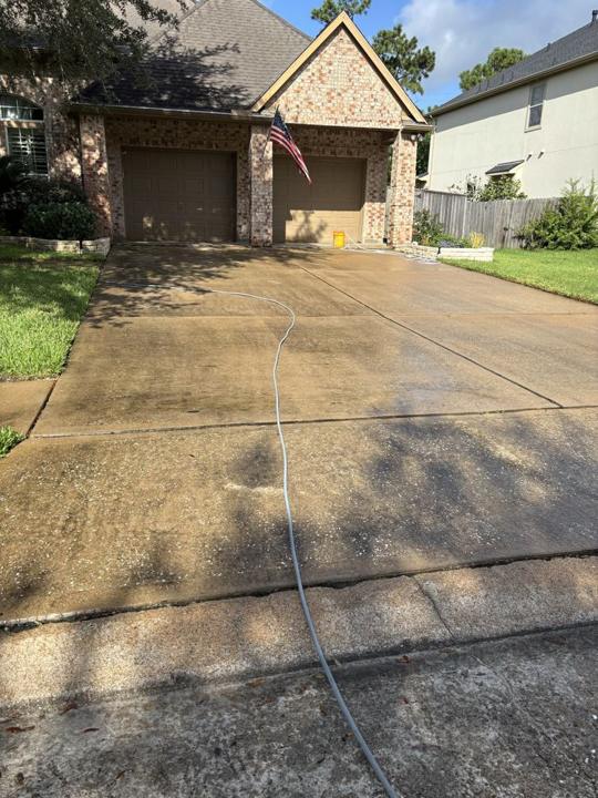 Two-car garage driveway before cleaning