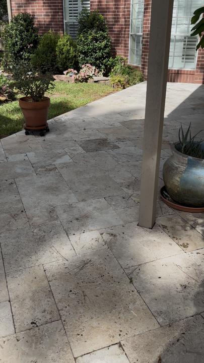 Travertine patio by the garden after cleaning