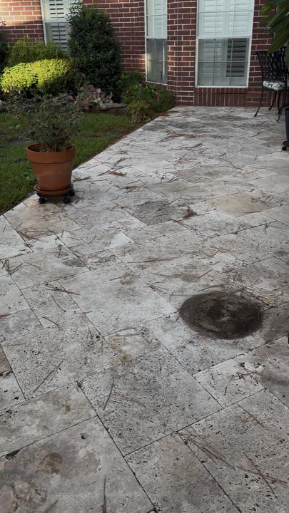Travertine patio by the garden before cleaning