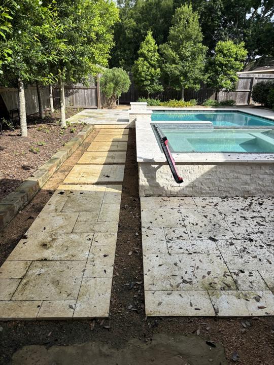 Travertine walkway and pool deck before cleaning