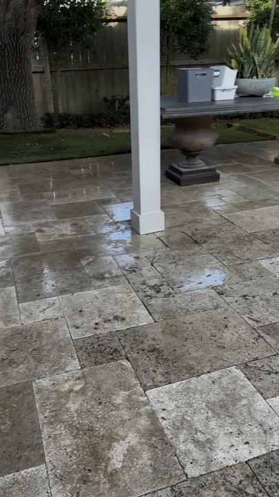 Covered travertine patio before cleaning