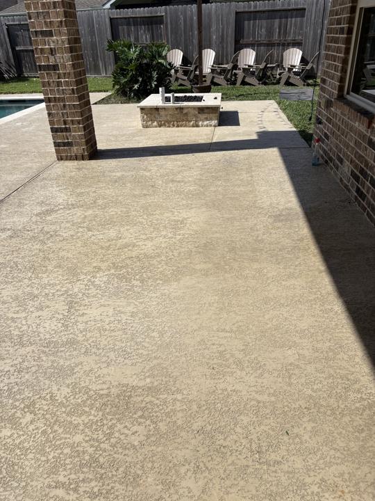 Textured concrete patio with fire pit after cleaning