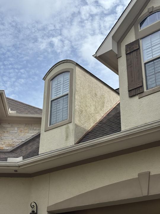 Stucco dormer before cleaning
