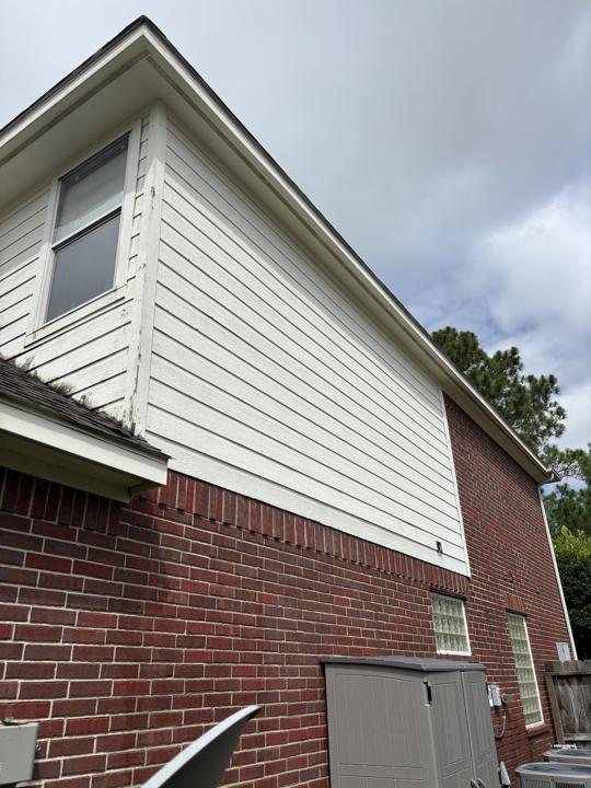 Two-story siding and brick after cleaning