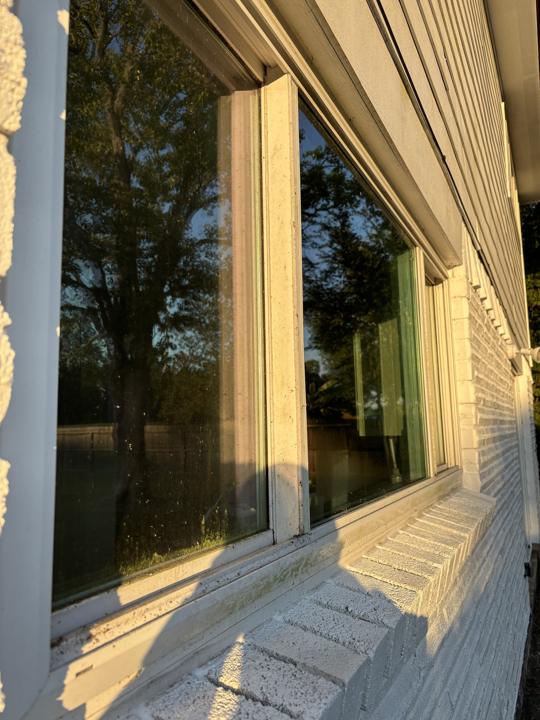 Window frames and brick sill before cleaning