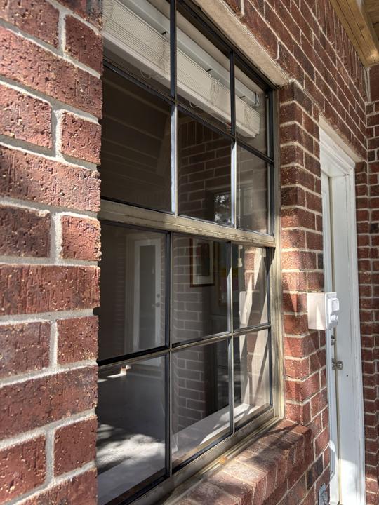 Divided-pane window on brick wall after cleaning