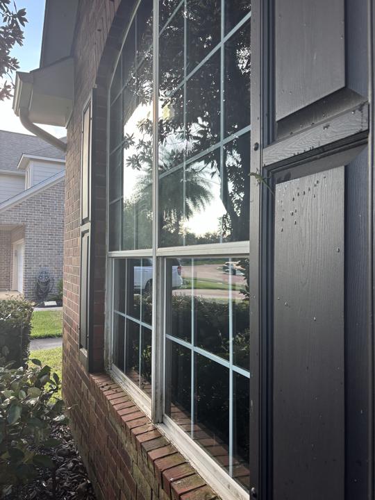 Arched window with shutters after cleaning