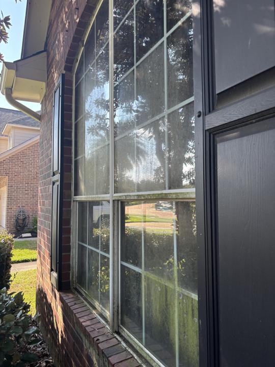 Arched window with shutters before cleaning